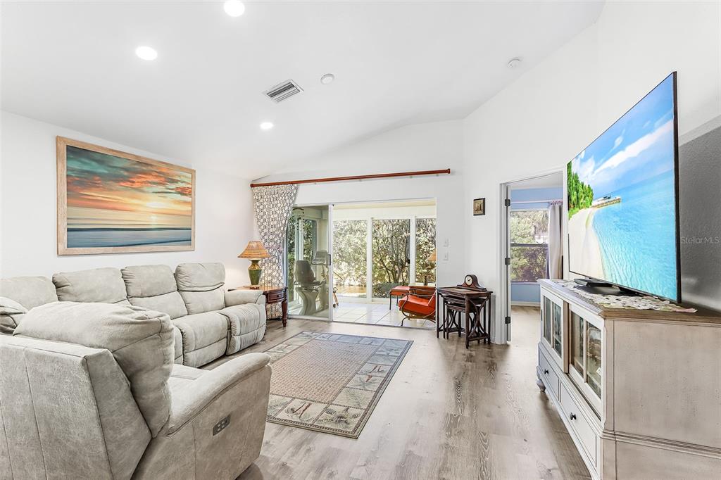 2031 Matecumbe Key Road Punta Gorda, FL 33955 - Photo 2 of 49 a living room with furniture flat screen tv and a large window