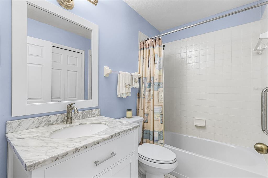 2031 Matecumbe Key Road Punta Gorda, FL 33955 - Photo 21 of 49 a bathroom with a granite countertop sink a toilet and shower