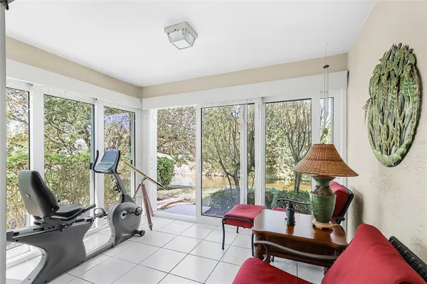 a living room with furniture and a floor to ceiling window