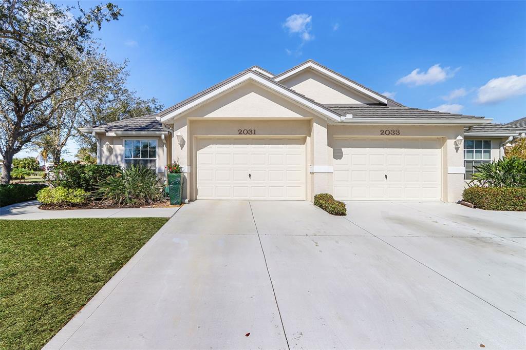 2031 Matecumbe Key Road Punta Gorda, FL 33955 - Photo 48 of 49 a front view of a house with a yard and garage