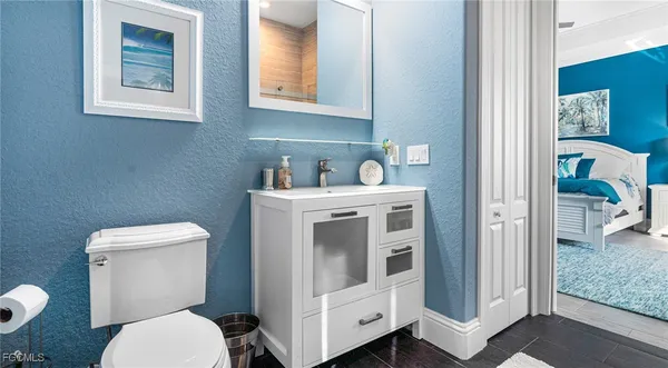 a bathroom with a toilet sink and mirror