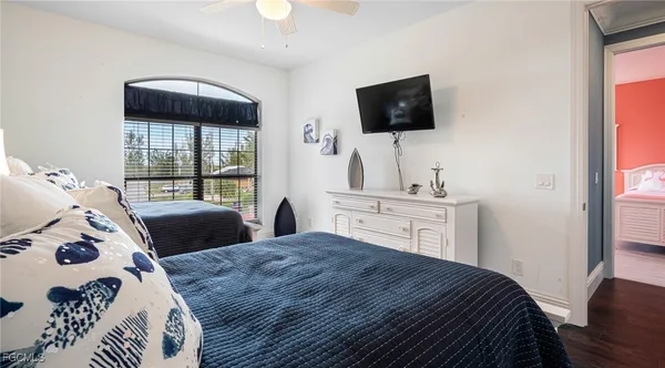 a bedroom with a bed and a television