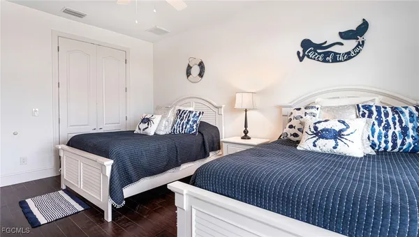 a bedroom with two beds and painted walls