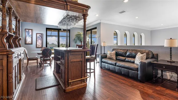 a living room with furniture a flat screen tv and a large window