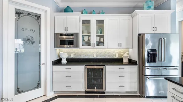 a kitchen with granite countertop a stove and cabinets