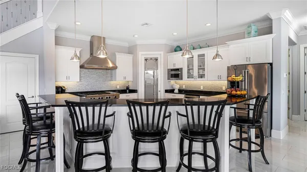 a view of a patio with a table and chairs under an umbrella