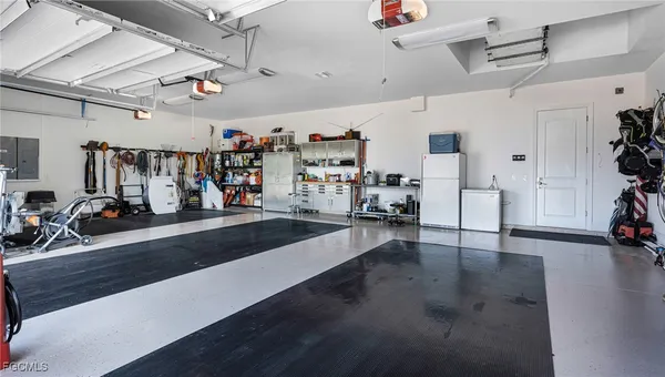 an aerial view of a house with swimming pool and large trees