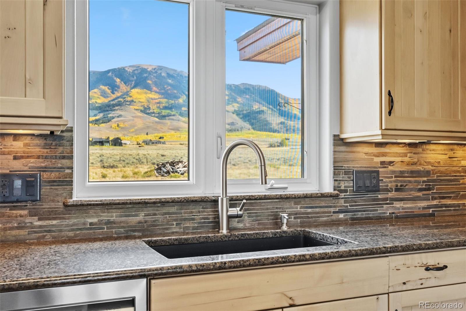 845 Elk Run Road Silverthorne, CO 80498 - Photo 15 of 50 a sink with a granite countertop window and a sink