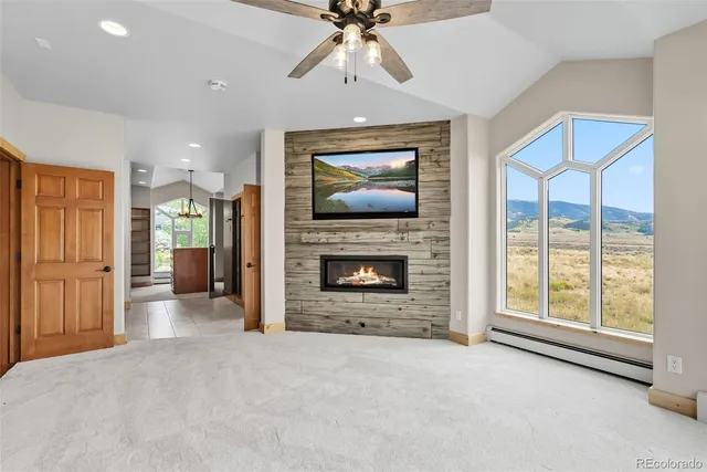 a view of an empty room with a fireplace and a window