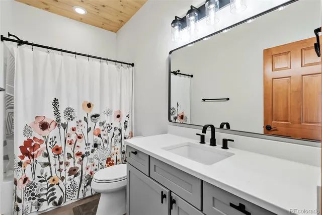 a view of a bedroom with wooden floor and windows