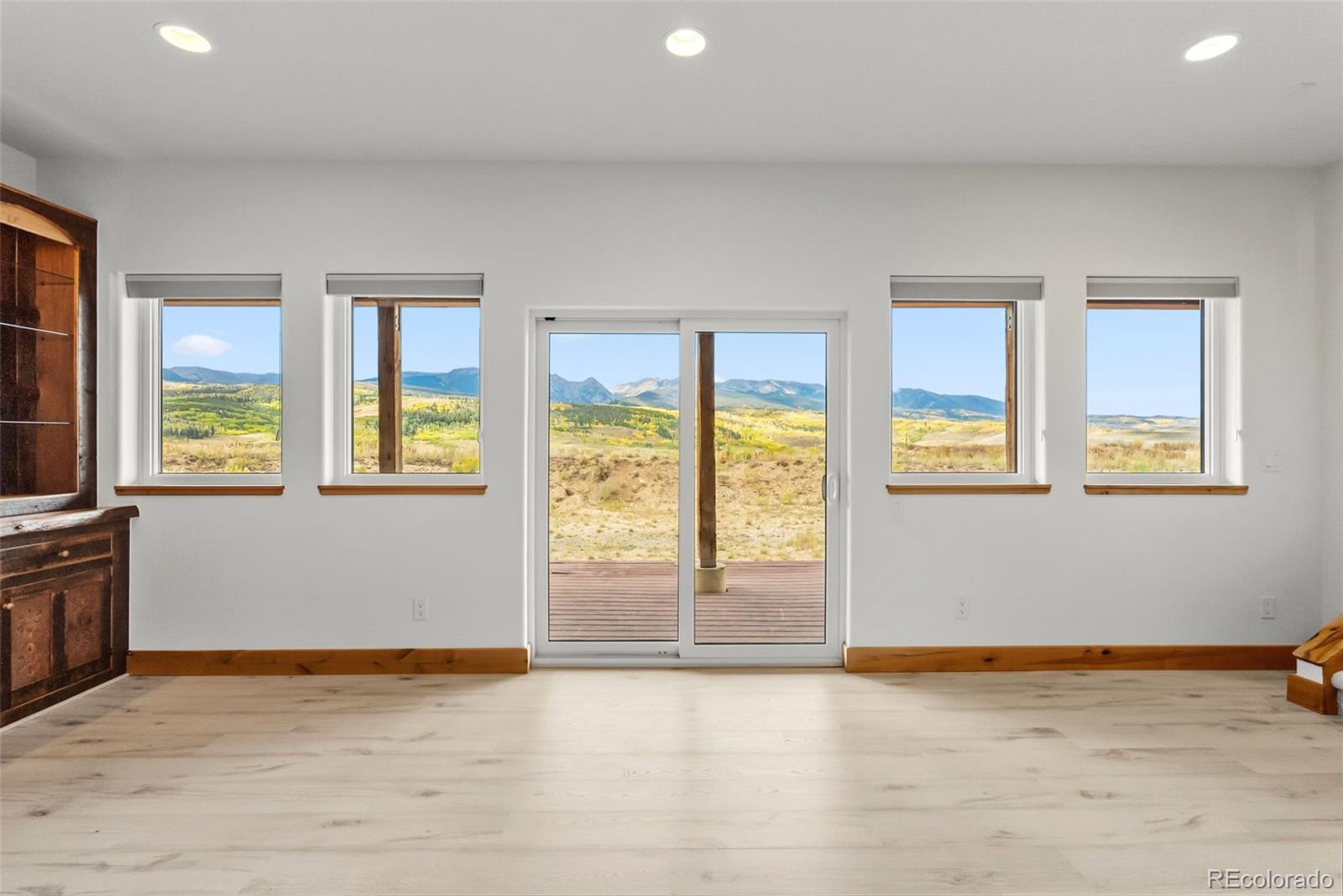 845 Elk Run Road Silverthorne, CO 80498 - Photo 34 of 50 an empty room with wooden floor and windows