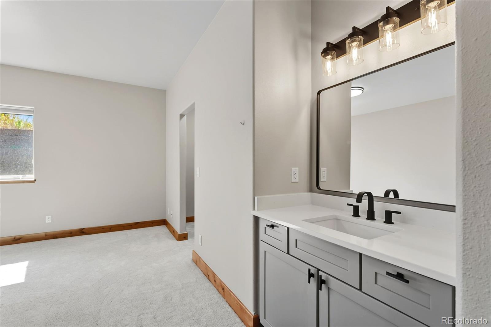 845 Elk Run Road Silverthorne, CO 80498 - Photo 49 of 50 a bathroom with a sink and a mirror