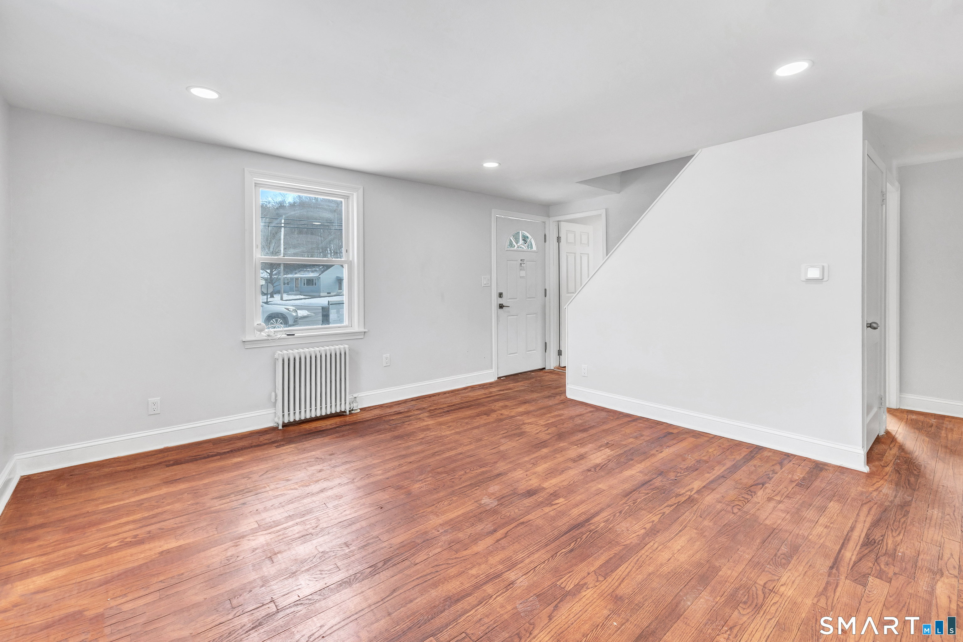 8 River Road East Haven, CT 06512 - Photo 16 of 45 an empty room with wooden floor and windows