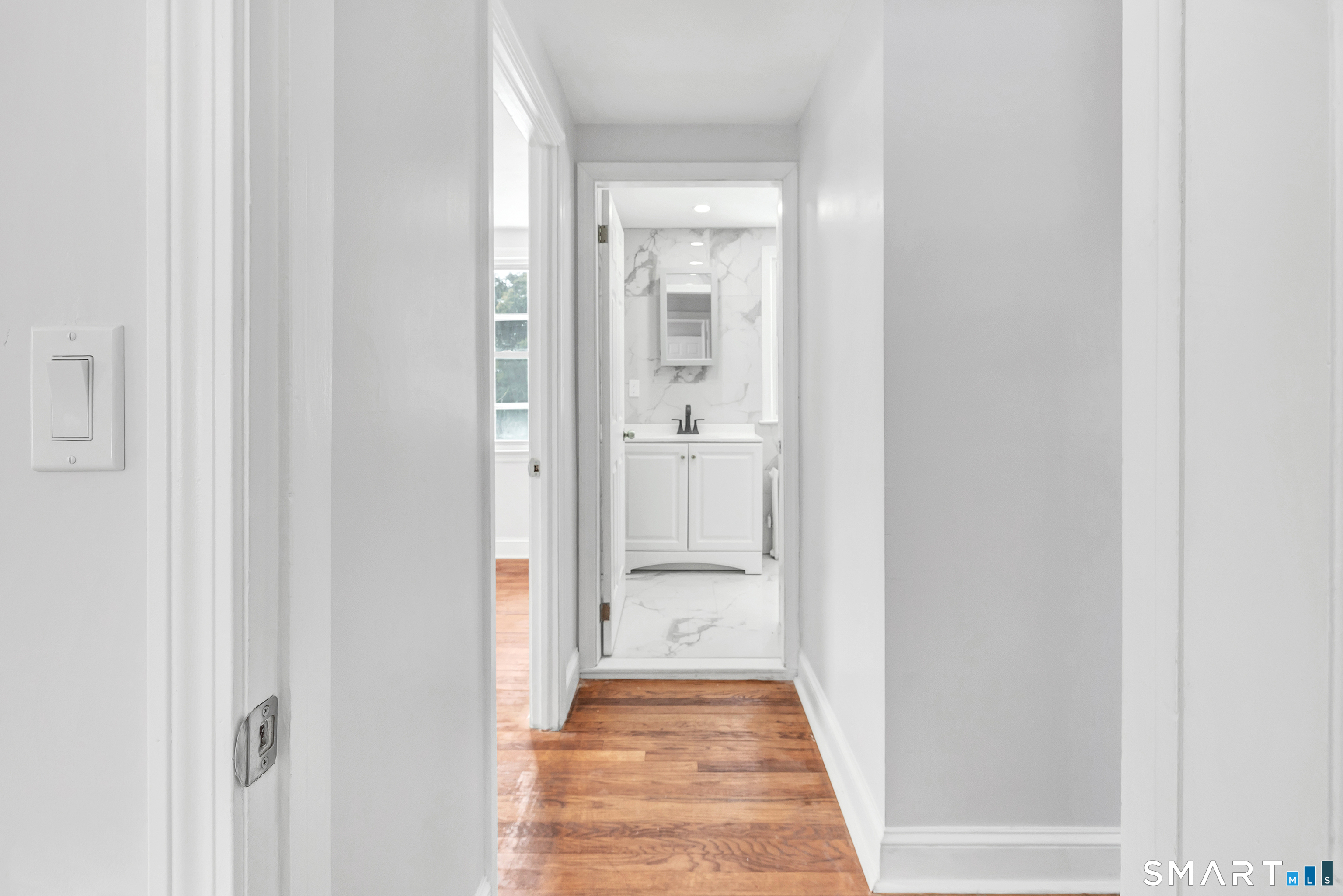 8 River Road East Haven, CT 06512 - Photo 28 of 45 a view of a hallway with wooden floor and a bathroom
