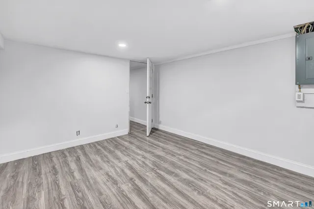 a view of an empty room with wooden floor