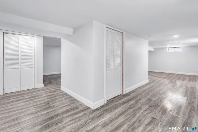 a view of hallway with wooden floor