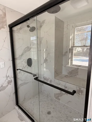 a bathroom with a glass shower door