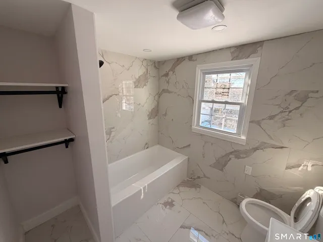 a bath room with a bath tub and a shower