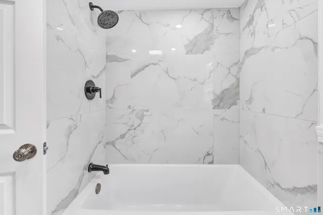 a bathroom with a bathtub and shower