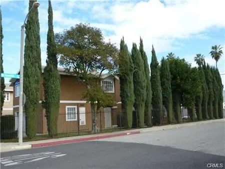a view of a house with a tree in front