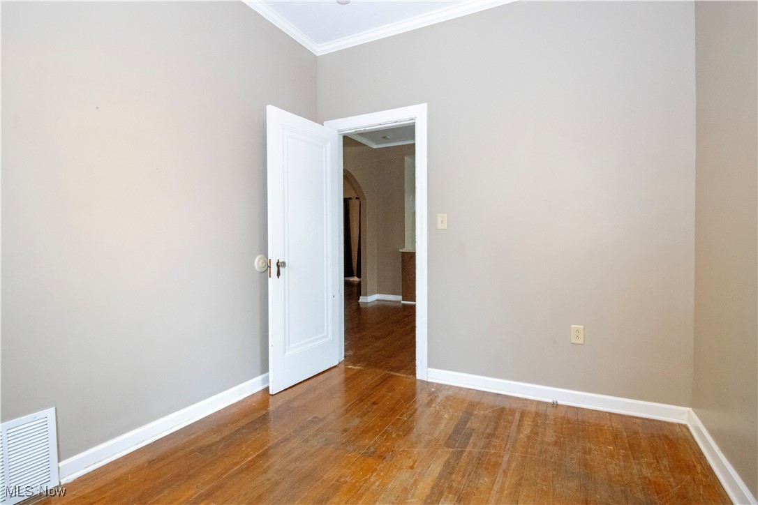 5699 Massillon Road Dalton, OH 44618 - Photo 9 of 24 Unfurnished room featuring crown molding and hardwood / wood-style flooring