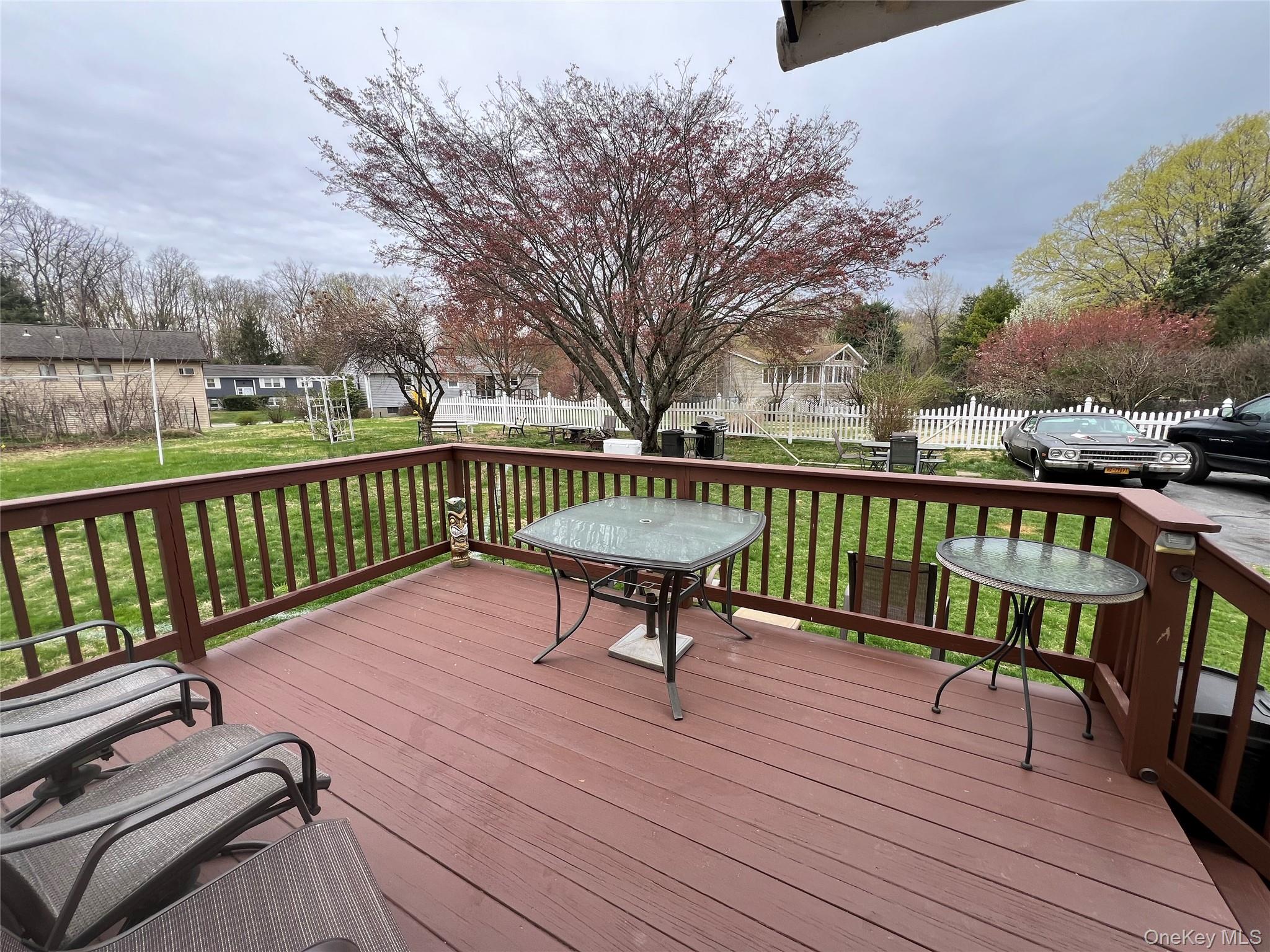 1731 Maple Avenue Peekskill, NY 10566 - Photo 15 of 15 a view of a roof deck with table and chairs and wooden floor