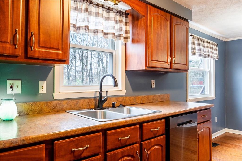 1069 Highfield Road Bethel Park, PA 15102 - Photo 12 of 41 a kitchen with stainless steel appliances granite countertop a sink and a window