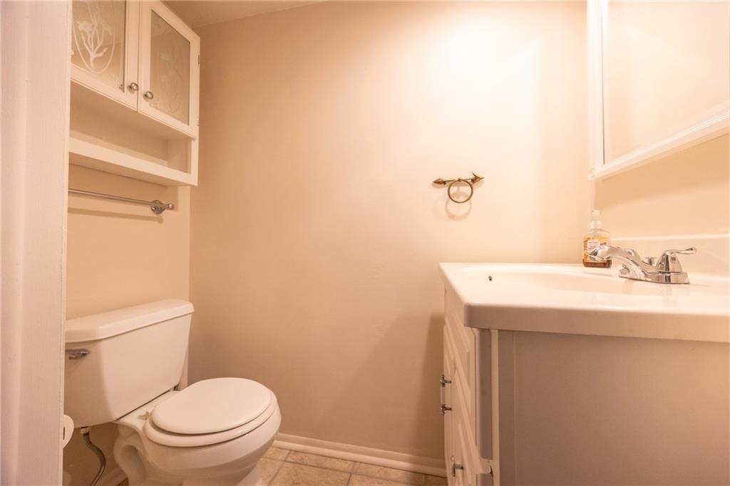 1069 Highfield Road Bethel Park, PA 15102 - Photo 17 of 41 a bathroom with a sink a toilet and a mirror