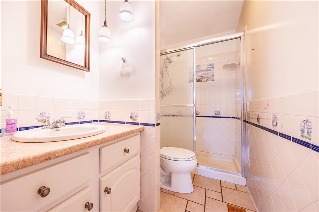 1069 Highfield Road Bethel Park, PA 15102 - Photo 21 of 41 a bathroom with a sink toilet and shower