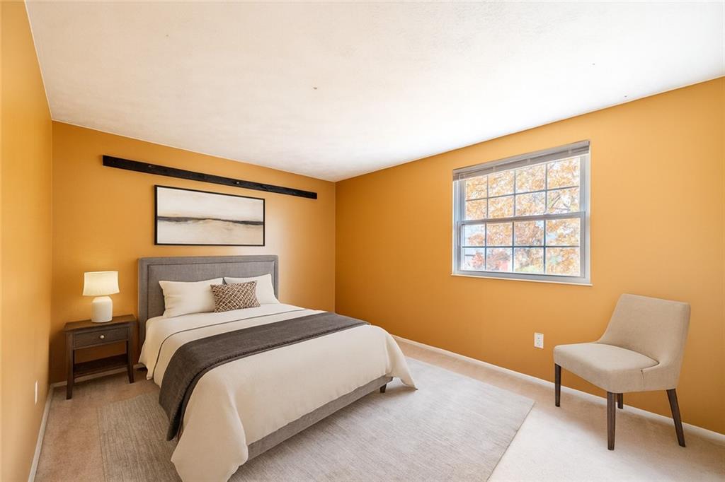 1069 Highfield Road Bethel Park, PA 15102 - Photo 22 of 41 a bedroom with a bed and a chair