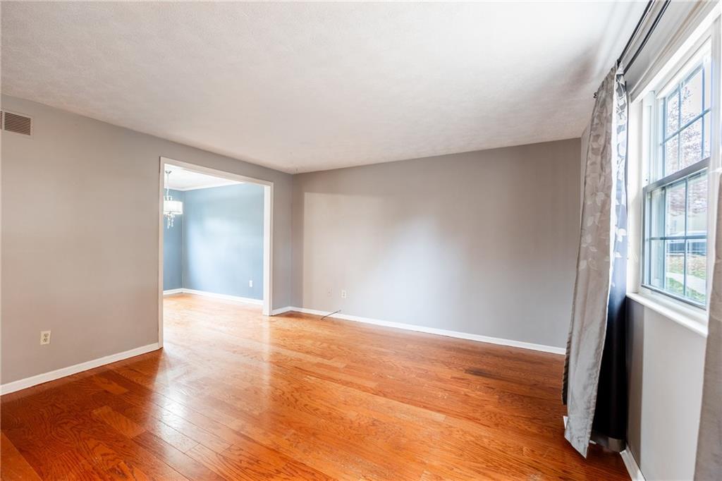 1069 Highfield Road Bethel Park, PA 15102 - Photo 4 of 41 a view of an empty room with wooden floor and a window