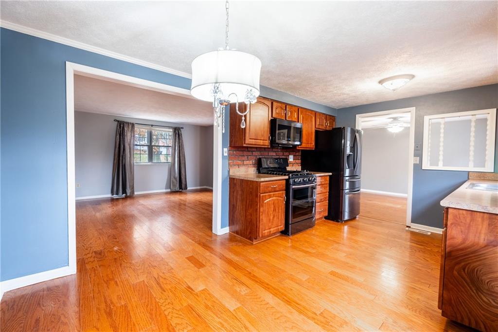 1069 Highfield Road Bethel Park, PA 15102 - Photo 7 of 41 a view of a kitchen with a sink and cabinets