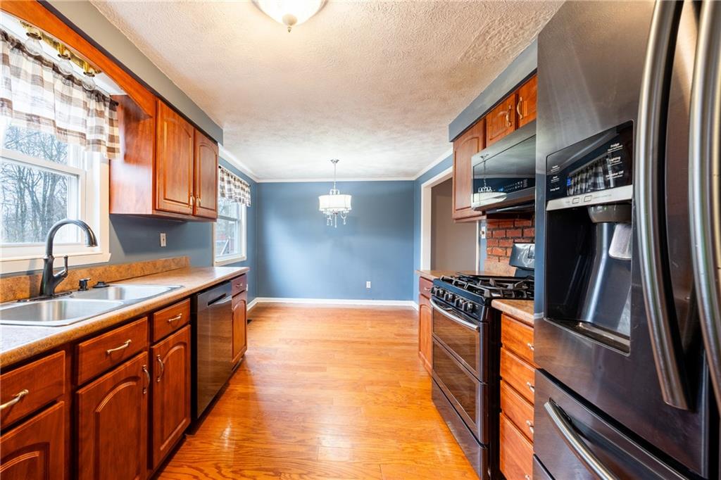 1069 Highfield Road Bethel Park, PA 15102 - Photo 8 of 41 a kitchen with granite countertop a sink and a stove top oven