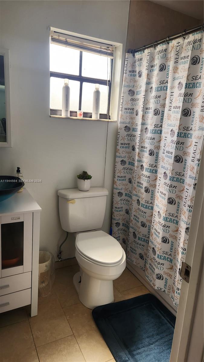 8254 Southwest 147th Place Miami, FL 33193 - Photo 11 of 14 a bathroom with a toilet a sink and a window