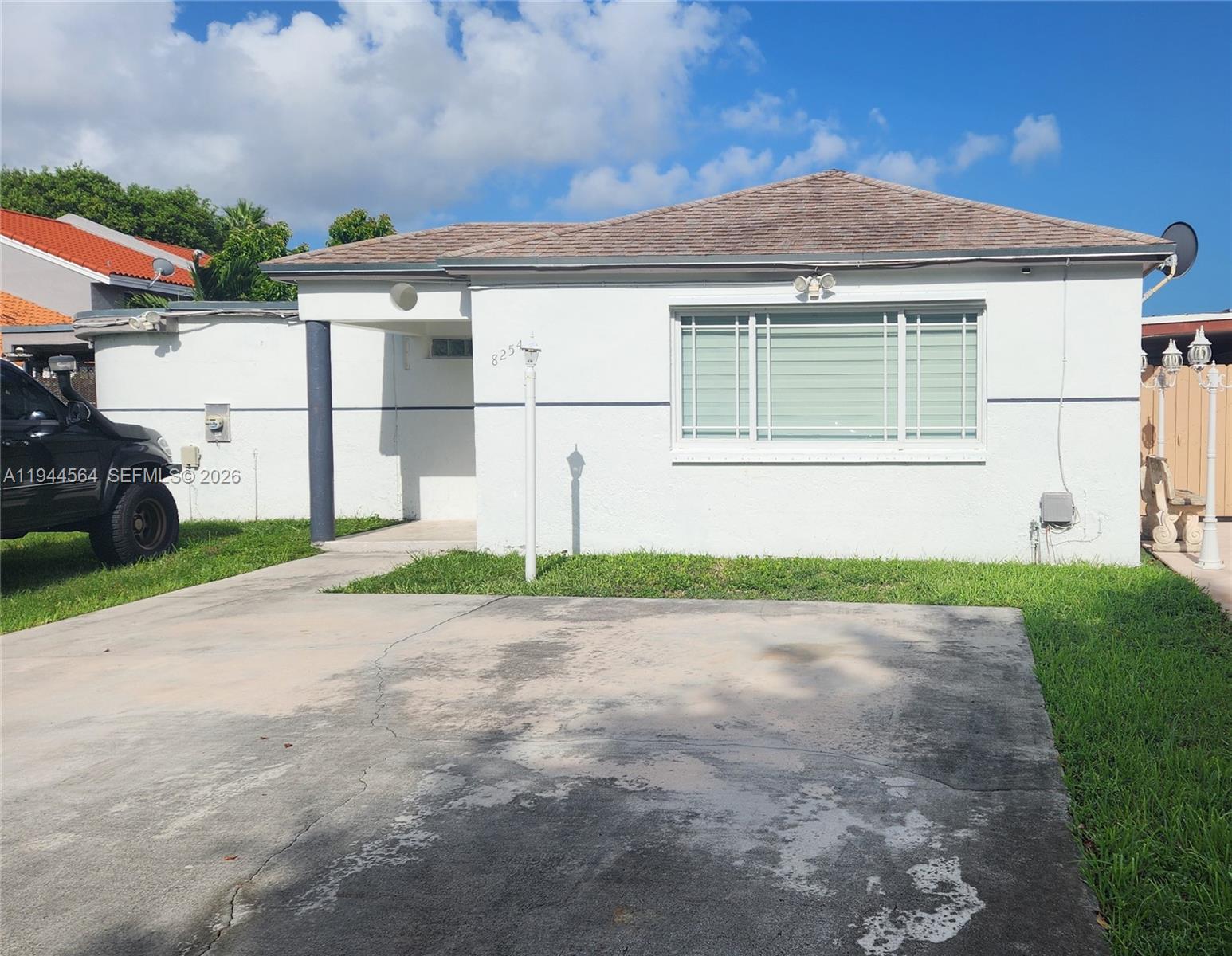 8254 Southwest 147th Place Miami, FL 33193 - Photo 5 of 14 a front view of a house with a yard and garage