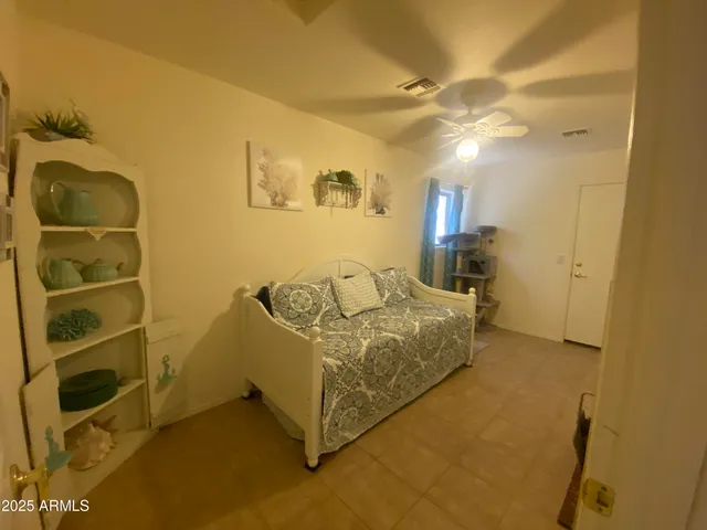 a spacious bedroom with a bed and a cabinets