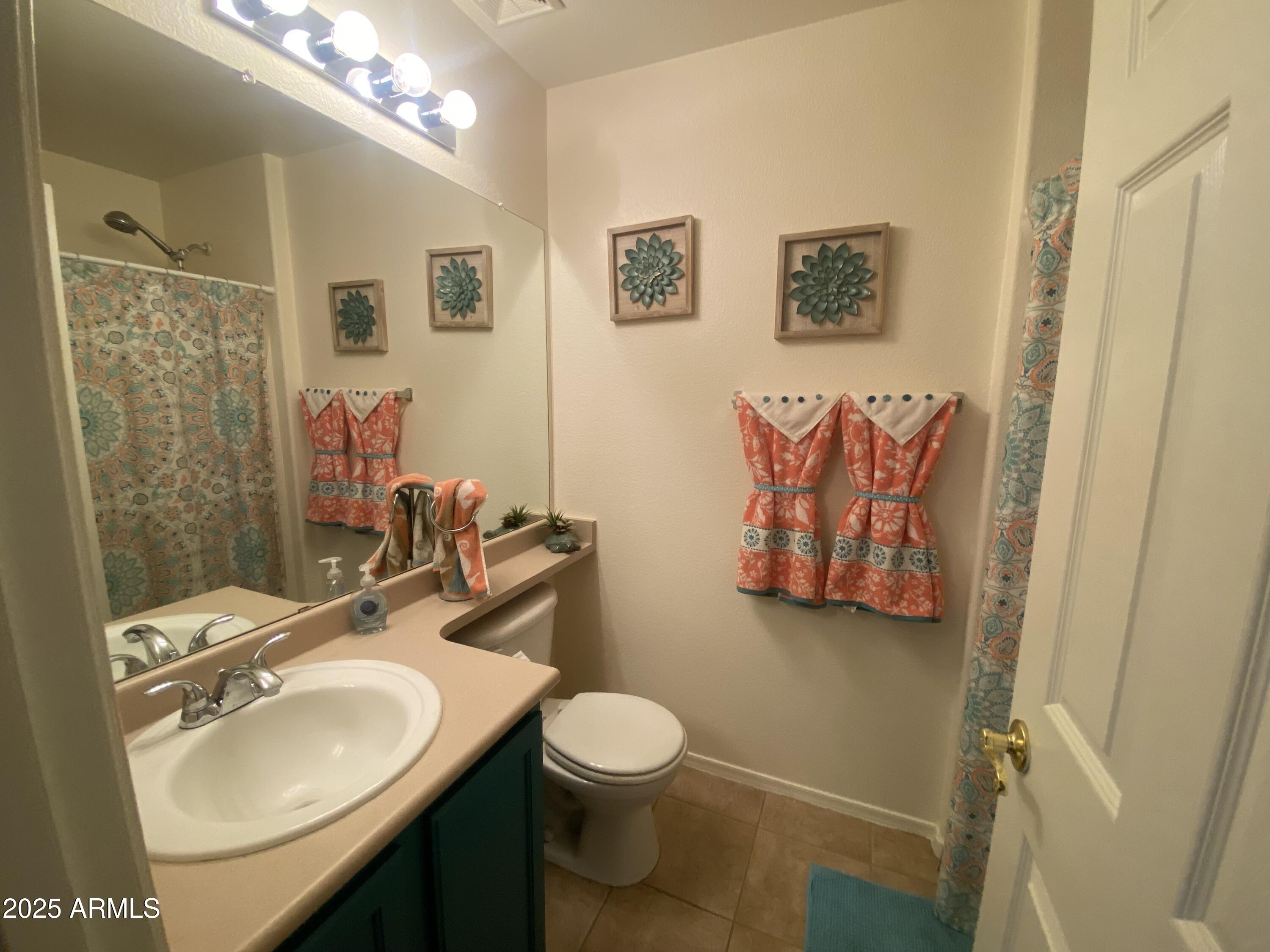 2101 South Meridian Road, Unit 431 Apache Junction, AZ 85120 - Photo 13 of 26 a bathroom with a toilet sink and mirror