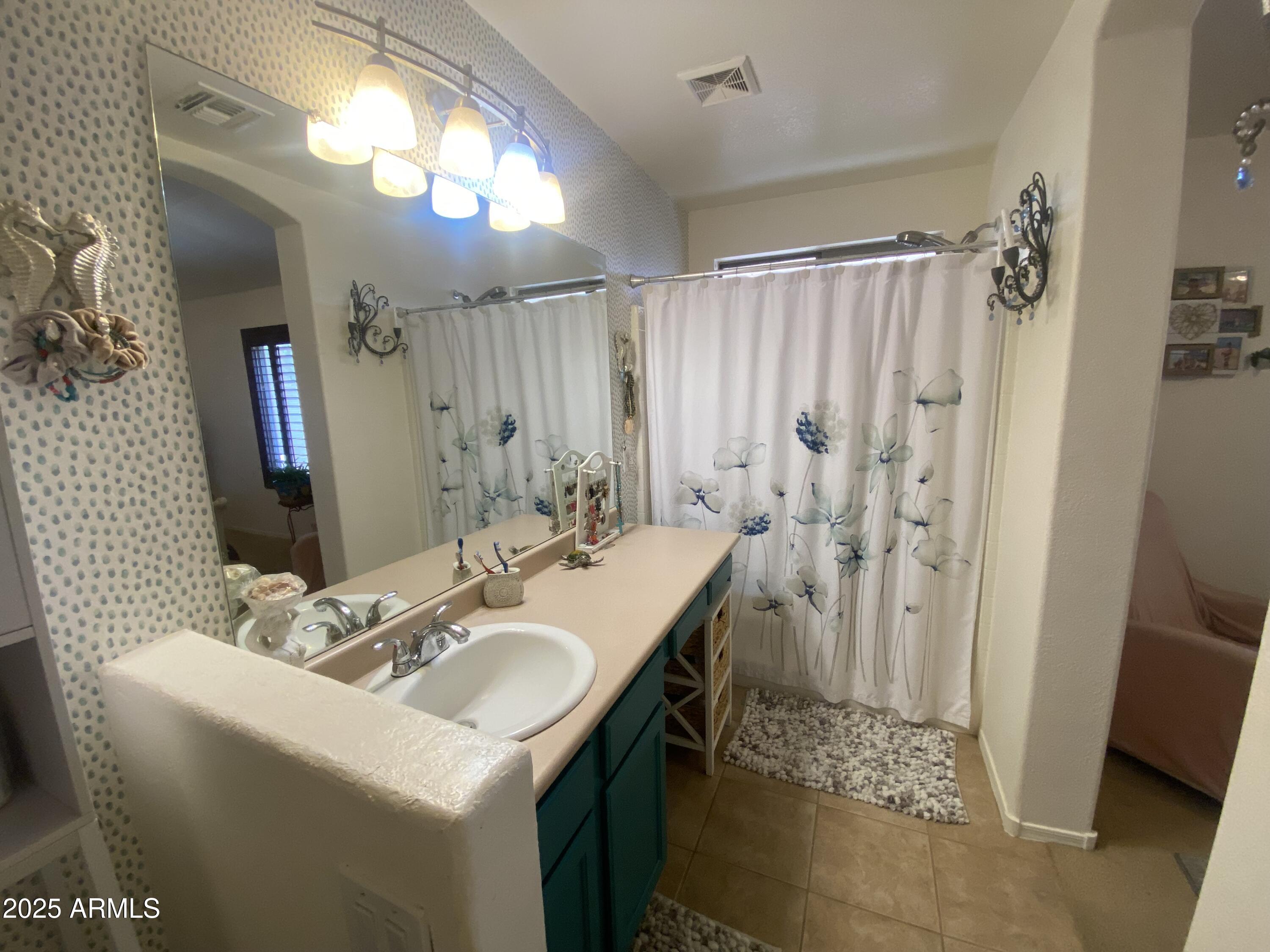 2101 South Meridian Road, Unit 431 Apache Junction, AZ 85120 - Photo 14 of 26 a bathroom with a sink double vanity and a mirror
