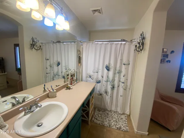 a bathroom with a sink double vanity and a mirror