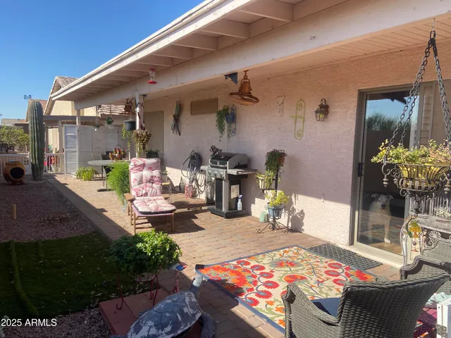 a view of a patio with table and chairs potted plants