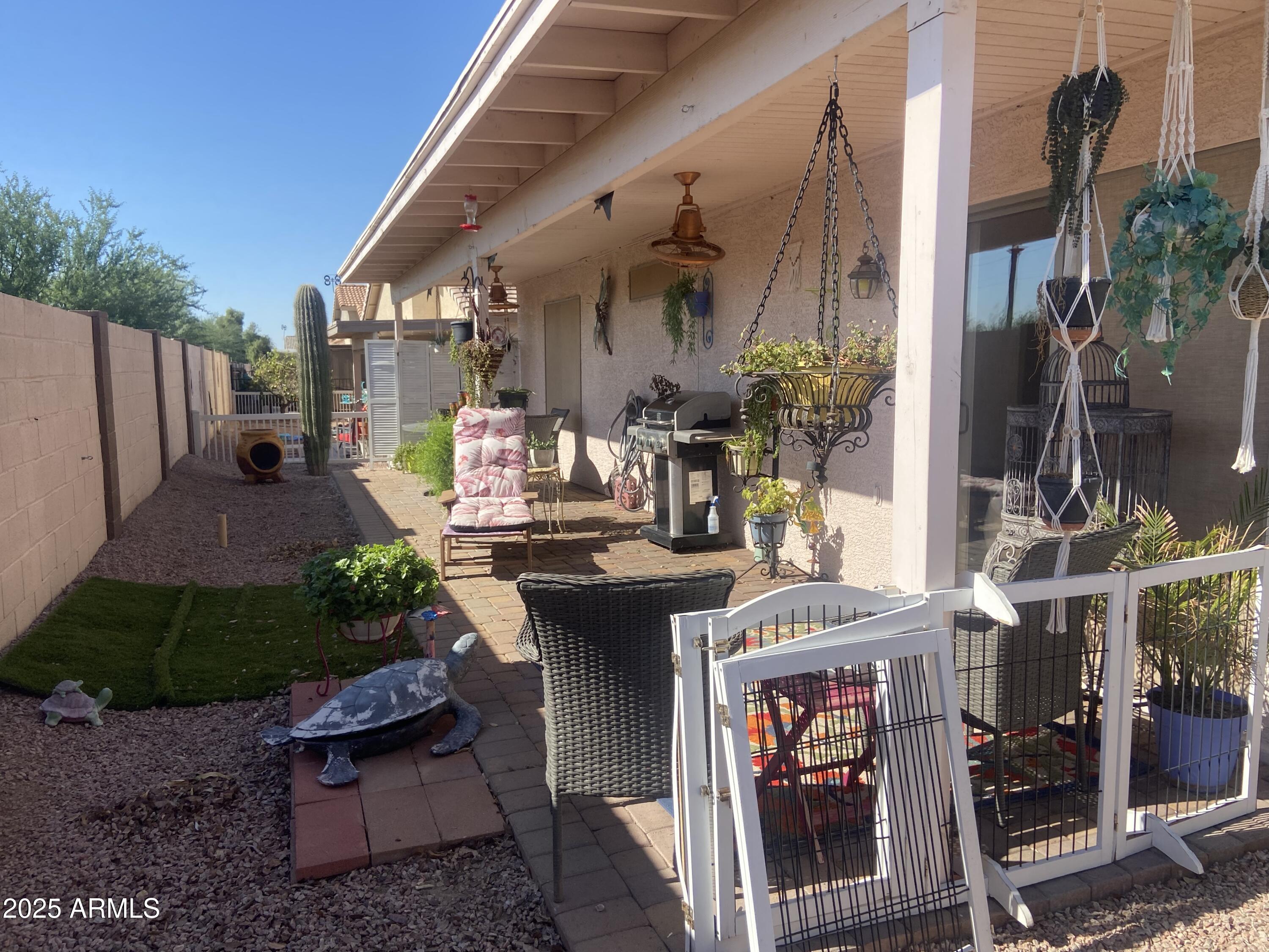 2101 South Meridian Road, Unit 431 Apache Junction, AZ 85120 - Photo 22 of 26 a view of a patio with table and chairs potted plants and floor to ceiling window