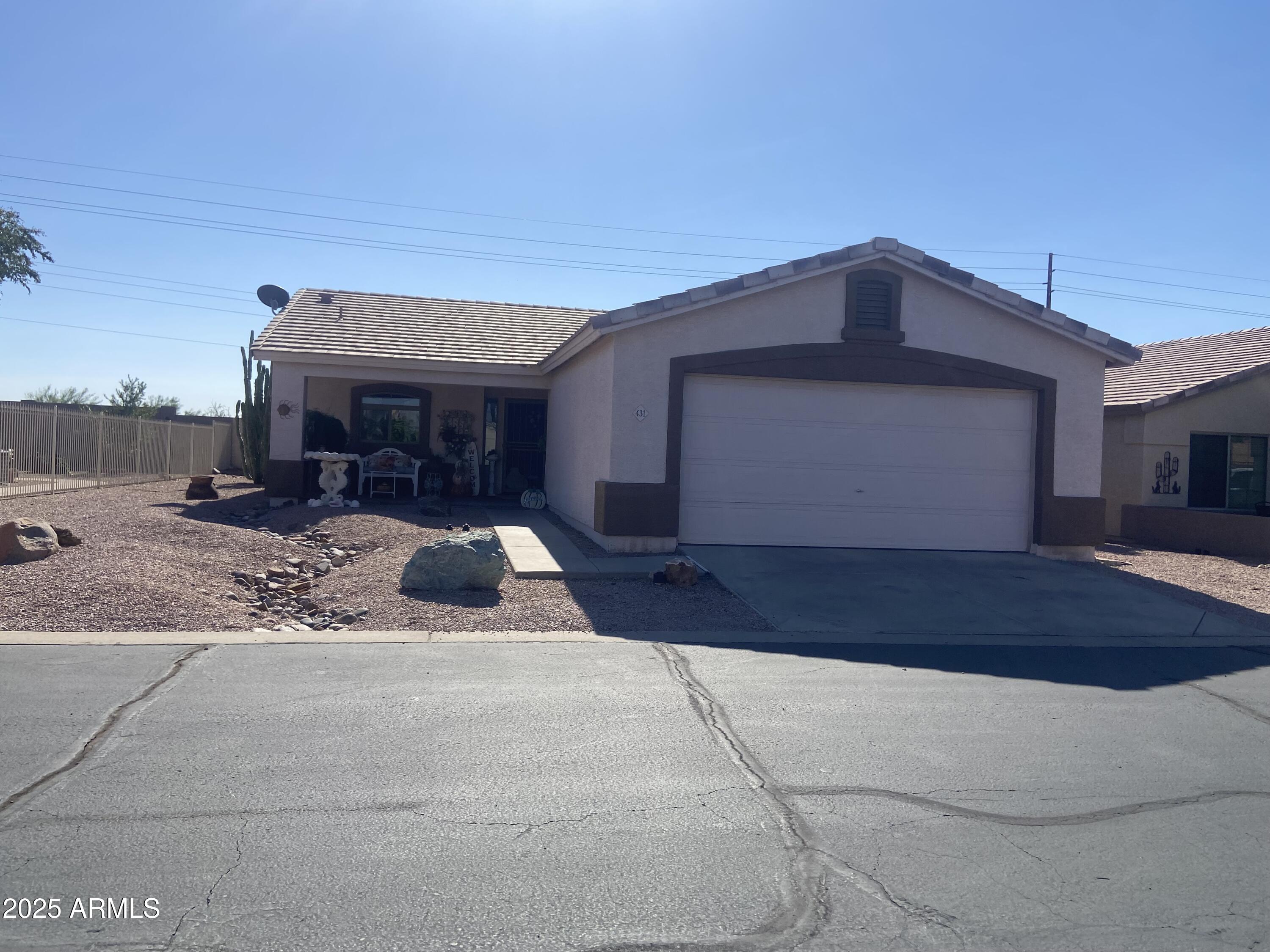 2101 South Meridian Road, Unit 431 Apache Junction, AZ 85120 - Photo 26 of 26 a front view of a house with a yard