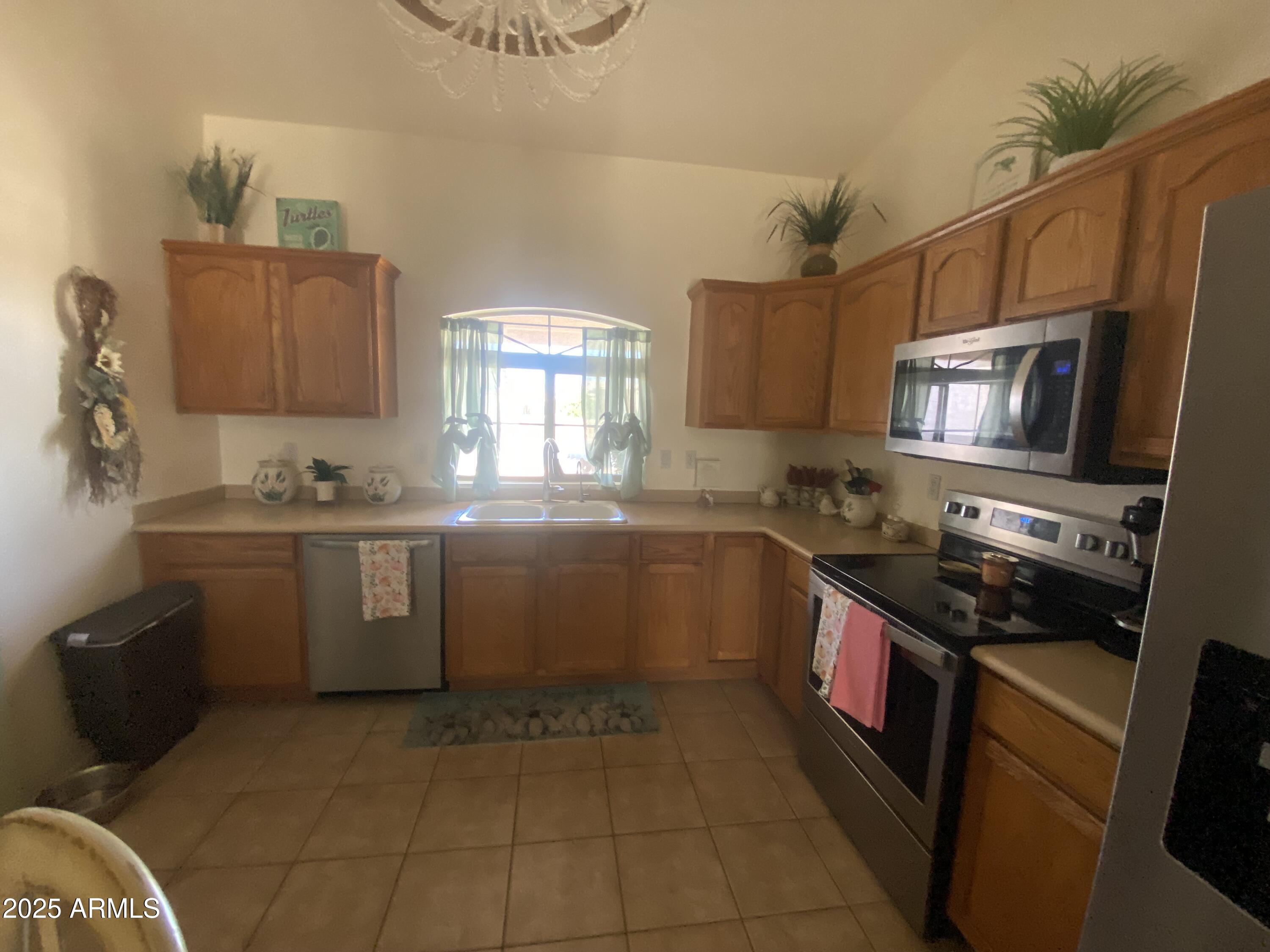 2101 South Meridian Road, Unit 431 Apache Junction, AZ 85120 - Photo 7 of 26 a kitchen with a sink a stove top oven and wooden floor