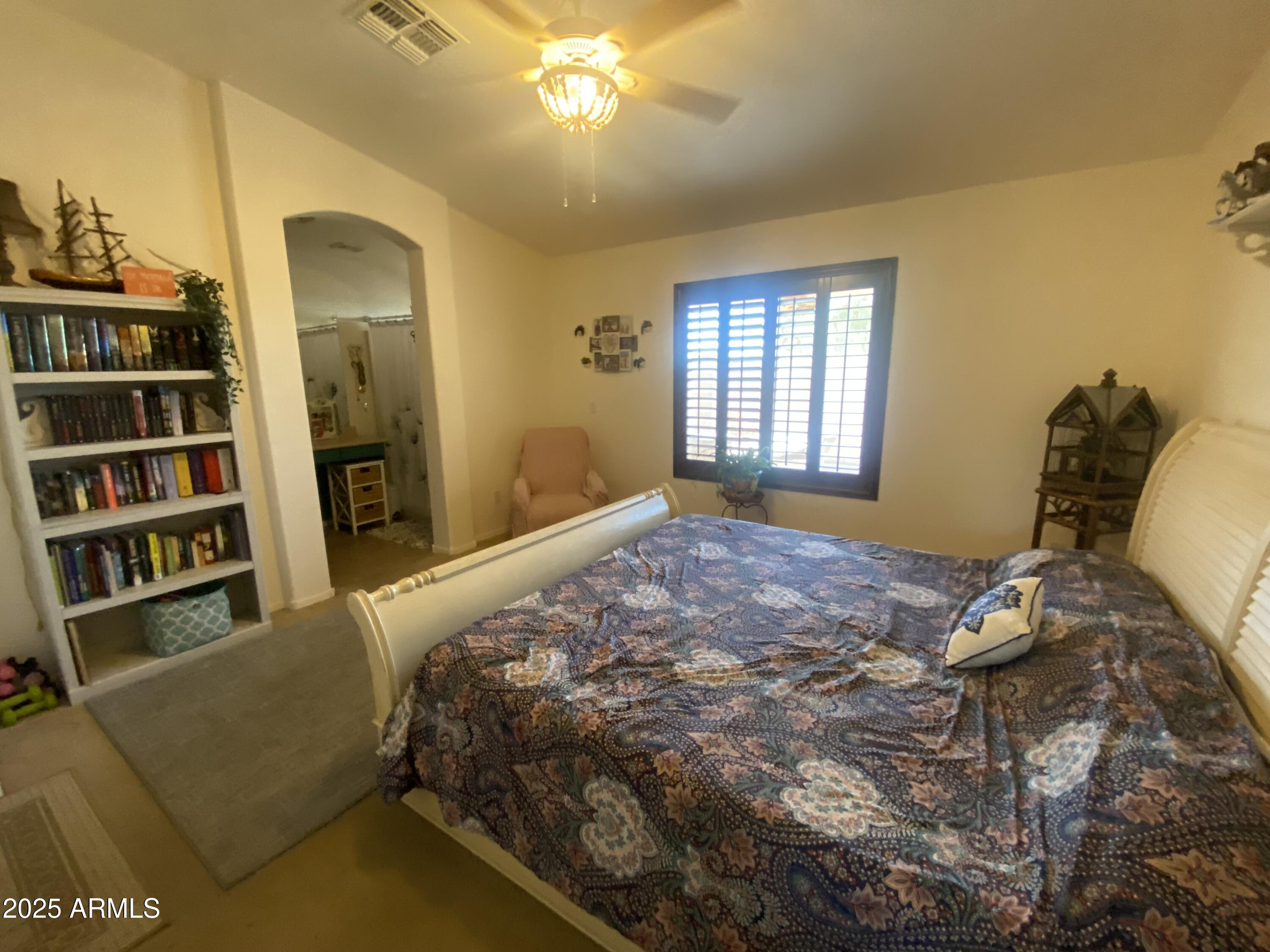 2101 South Meridian Road, Unit 431 Apache Junction, AZ 85120 - Photo 9 of 26 a bedroom with a bed and a book shelf