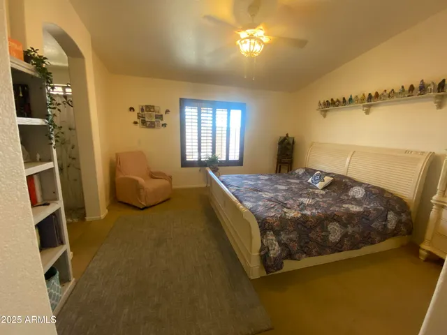 a bedroom with a bed dresser and a window