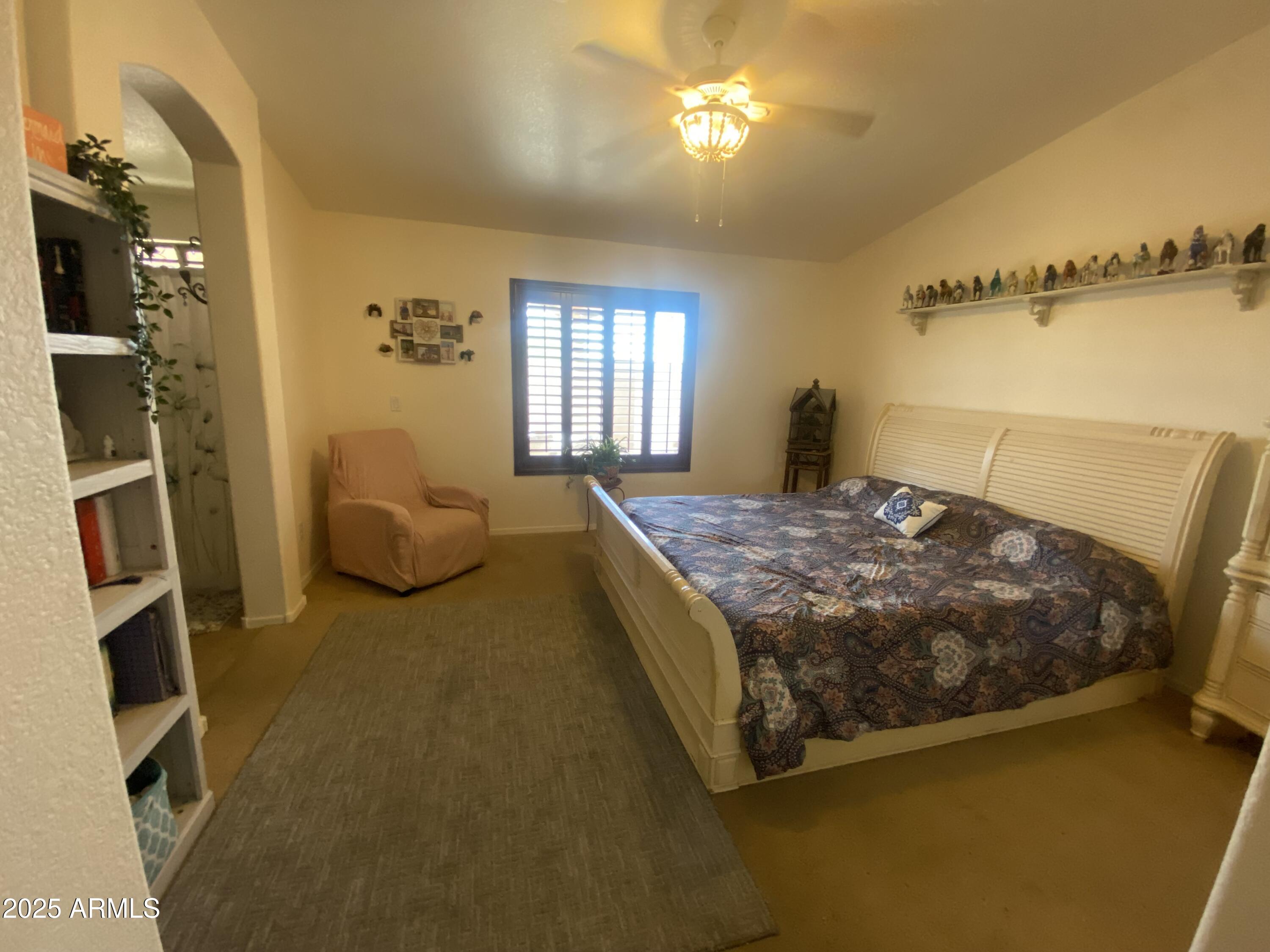 2101 South Meridian Road, Unit 431 Apache Junction, AZ 85120 - Photo 10 of 26 a bedroom with a bed dresser and a window