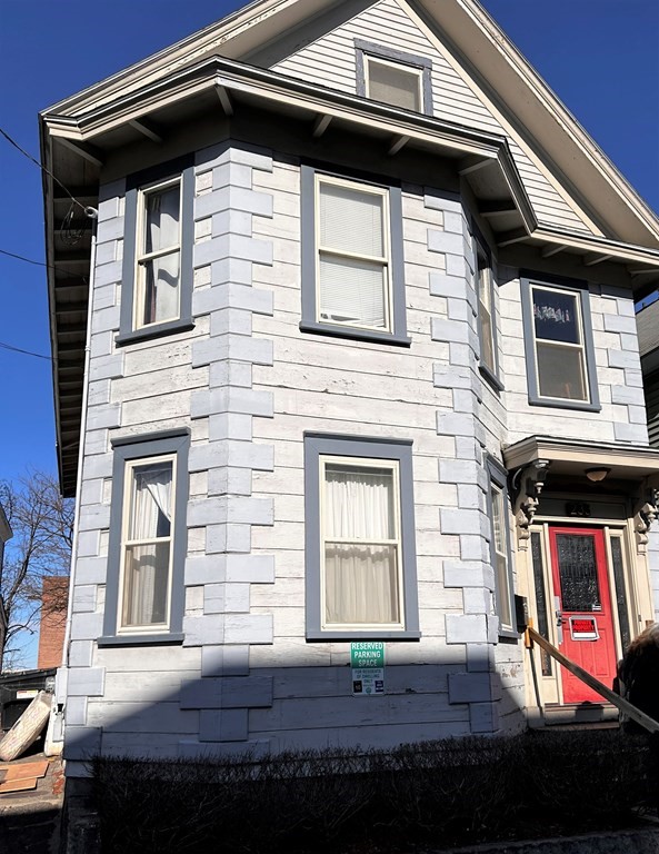 233 Appleton Street Lowell, MA 01852 - Photo 1 of 6 a front view of a house with yard