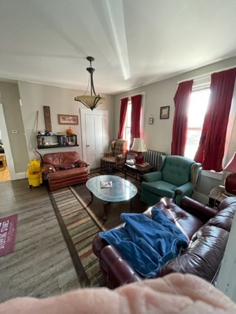 233 Appleton Street Lowell, MA 01852 - Photo 3 of 6 a living room with furniture and wooden floor