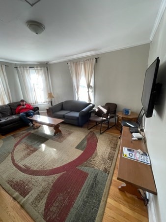 233 Appleton Street Lowell, MA 01852 - Photo 4 of 6 a gym hall with a couch and a window