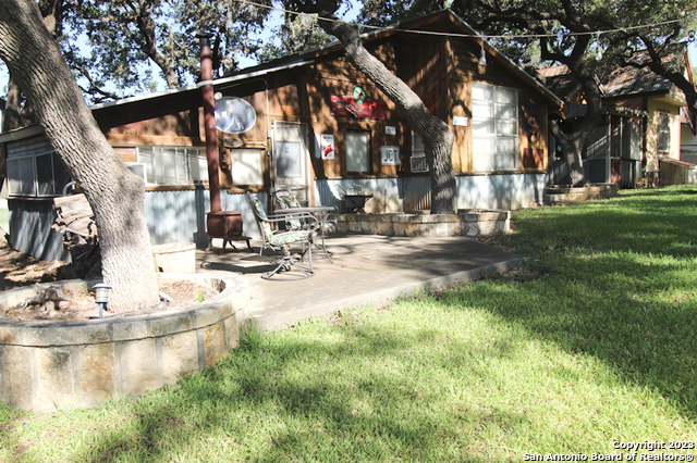955 Faurie Road, Unit CEDAR CABIN Lakehills, TX 78063 - Photo 1 of 21 a view of swimming pool with a yard and sitting area